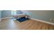 Bright bedroom features modern wood flooring, a window, and a calming blue accent wall at 549 Greenridge Ln, Loganville, GA 30052