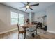 Bright dining area featuring a modern ceiling fan and natural light from large window at 549 Greenridge Ln, Loganville, GA 30052