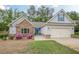 Beautiful single-Gathering home with stone accents, blue trim, two-car garage, and a well-maintained lawn at 549 Greenridge Ln, Loganville, GA 30052