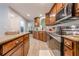 Well-equipped kitchen featuring granite countertops, stainless steel appliances, and wood cabinets at 549 Greenridge Ln, Loganville, GA 30052