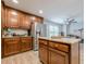 Bright eat-in kitchen with stainless steel refrigerator, center island, and wood cabinets at 549 Greenridge Ln, Loganville, GA 30052