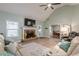 Welcoming living room showcasing a stone fireplace, vaulted ceiling, and views of the dining area at 549 Greenridge Ln, Loganville, GA 30052