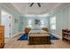 Bright main bedroom featuring a trey ceiling, a fan, blue walls, and a wooden chest at 549 Greenridge Ln, Loganville, GA 30052