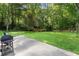 Spacious backyard with a well-maintained lawn, trees and barbecue at 1438 Heritage Glen Dr, Marietta, GA 30068
