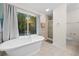 Luxurious bathroom featuring a freestanding tub, a glass enclosed shower, and modern fixtures at 1438 Heritage Glen Dr, Marietta, GA 30068