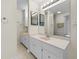 Well-lit bathroom with double sinks, white cabinets, and modern fixtures for a clean and functional space at 1438 Heritage Glen Dr, Marietta, GA 30068