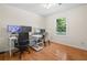 Bedroom with hardwood floors and computer setup near the window at 1438 Heritage Glen Dr, Marietta, GA 30068