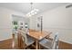 Bright dining room with modern lighting and hardwood floors flows into the living room, creating an open, inviting space at 1438 Heritage Glen Dr, Marietta, GA 30068