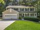 Charming two-story home with black shutters, covered porch and a well-manicured lawn at 1438 Heritage Glen Dr, Marietta, GA 30068