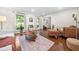 Sun-filled living room with hardwood floors, stylish shutters, and a cozy seating area provides a warm and inviting atmosphere at 1438 Heritage Glen Dr, Marietta, GA 30068
