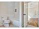 Bathroom featuring a tiled shower/tub combo, white tile, and neutral flooring at 2179 William Way, Atlanta, GA 30345