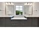 Contemporary bathroom featuring double sinks, modern fixtures, quartz countertops, and outside view at 2179 William Way, Atlanta, GA 30345