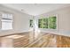 Sunlit bedroom with hardwood floors, large windows with views of the yard, and white trim at 2179 William Way, Atlanta, GA 30345