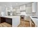 Modern kitchen with a waterfall island, stainless steel appliances, and white cabinetry at 2179 William Way, Atlanta, GA 30345