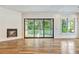 Bright living room with fireplace, hardwood floors, and sliding doors to a screened-in porch, blending indoor and outdoor spaces at 2179 William Way, Atlanta, GA 30345