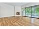 Open-concept living room with hardwood floors, fireplace, and access to a screened porch at 2179 William Way, Atlanta, GA 30345