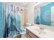 Bathroom with a shower-tub combination featuring colorful curtains that give it a unique design at 2935 Sawgrass Sw Trl, Lilburn, GA 30047