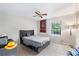 Serene bedroom featuring carpeted floors, a ceiling fan, and a large window with backyard views at 2935 Sawgrass Sw Trl, Lilburn, GA 30047