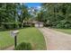 Charming single-story home with a two-car garage and a long driveway surrounded by lush greenery at 2935 Sawgrass Sw Trl, Lilburn, GA 30047