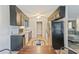 Efficient kitchen with black cabinets, stainless steel appliances, and neutral countertops for practical meal preparation at 2935 Sawgrass Sw Trl, Lilburn, GA 30047