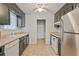Galley kitchen includes stainless steel appliances, white countertops, and ample cabinet space for modern convenience at 2935 Sawgrass Sw Trl, Lilburn, GA 30047