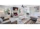Cozy living room with a fireplace, large windows, and an open layout connected to the dining area at 2935 Sawgrass Sw Trl, Lilburn, GA 30047