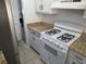 Cozy kitchen includes a gas stove, laminate counters, and plenty of cabinet space at 437 Saint Ives Sq, Stone Mountain, GA 30083