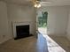 Living room featuring a fireplace and glass door leading to the outside at 437 Saint Ives Sq, Stone Mountain, GA 30083