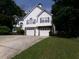 Charming two-story home with white siding, stone accents, two-car garage, and a well-maintained front yard at 49 Brinkley Ct, Dallas, GA 30157
