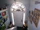 Inviting foyer showcasing artwork and decor leading to front door with a decorative light fixture at 49 Brinkley Ct, Dallas, GA 30157