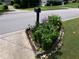 Landscaped front yard featuring a decorative mailbox with colorful flowers and manicured lawn at 49 Brinkley Ct, Dallas, GA 30157