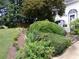 Landscaped front yard with lush greenery, mulch, and a variety of plants, offering curb appeal at 49 Brinkley Ct, Dallas, GA 30157