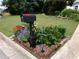 Charming landscaped yard featuring a decorative mailbox adorned with colorful flowers and lush green lawn at 49 Brinkley Ct, Dallas, GA 30157