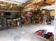 Spacious garage featuring storage shelves, offering room for vehicles and projects with exposed ceiling at 49 Brinkley Ct, Dallas, GA 30157