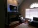 Cozy living room with stone fireplace, dark wood floors, and a comfortable armchair for relaxation at 49 Brinkley Ct, Dallas, GA 30157