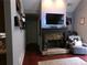 Cozy living room with stone fireplace, dark wood floors, and a comfortable armchair for relaxation at 49 Brinkley Ct, Dallas, GA 30157