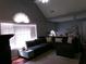Inviting living room featuring vaulted ceilings, an oversized sectional sofa, and bright natural light from large windows at 49 Brinkley Ct, Dallas, GA 30157