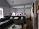 Inviting living room featuring vaulted ceilings, an oversized sectional sofa, and bright natural light from large windows at 49 Brinkley Ct, Dallas, GA 30157