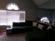 Inviting living room featuring vaulted ceilings, an oversized sectional sofa, and bright natural light from large windows at 49 Brinkley Ct, Dallas, GA 30157