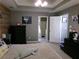 Stylish bedroom features a neutral color scheme, tray ceiling, and en-suite bathroom for added convenience at 49 Brinkley Ct, Dallas, GA 30157