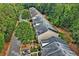 Aerial view of townhomes in a neighborhood with tree-lined streets at 440 Berckman Nw Dr, Lilburn, GA 30047