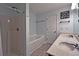 Bright bathroom with dual vanity, bathtub and shower combo at 440 Berckman Nw Dr, Lilburn, GA 30047