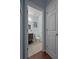 Charming half bathroom with modern fixtures and wood-look tile floors at 440 Berckman Nw Dr, Lilburn, GA 30047
