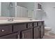 Bathroom featuring double vanity with dark wood cabinets, white counter tops, and light grey walls at 440 Berckman Nw Dr, Lilburn, GA 30047