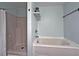 Bathroom featuring tub-shower combo, vanity sink, and blue walls at 440 Berckman Nw Dr, Lilburn, GA 30047