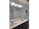 Bathroom with large mirror, double vanity sink with white countertop and dark cabinets at 440 Berckman Nw Dr, Lilburn, GA 30047