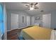 Bedroom featuring hardwood floors, a ceiling fan, closet, and neutral paint at 440 Berckman Nw Dr, Lilburn, GA 30047
