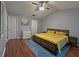 Bedroom featuring hardwood floors, a ceiling fan, closet, and neutral paint at 440 Berckman Nw Dr, Lilburn, GA 30047