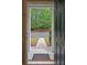 Open doorway view showcasing the pathway to parking spots framed by columns and lush trees at 440 Berckman Nw Dr, Lilburn, GA 30047