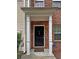Inviting entryway featuring a covered porch with classic columns and a black front door at 440 Berckman Nw Dr, Lilburn, GA 30047